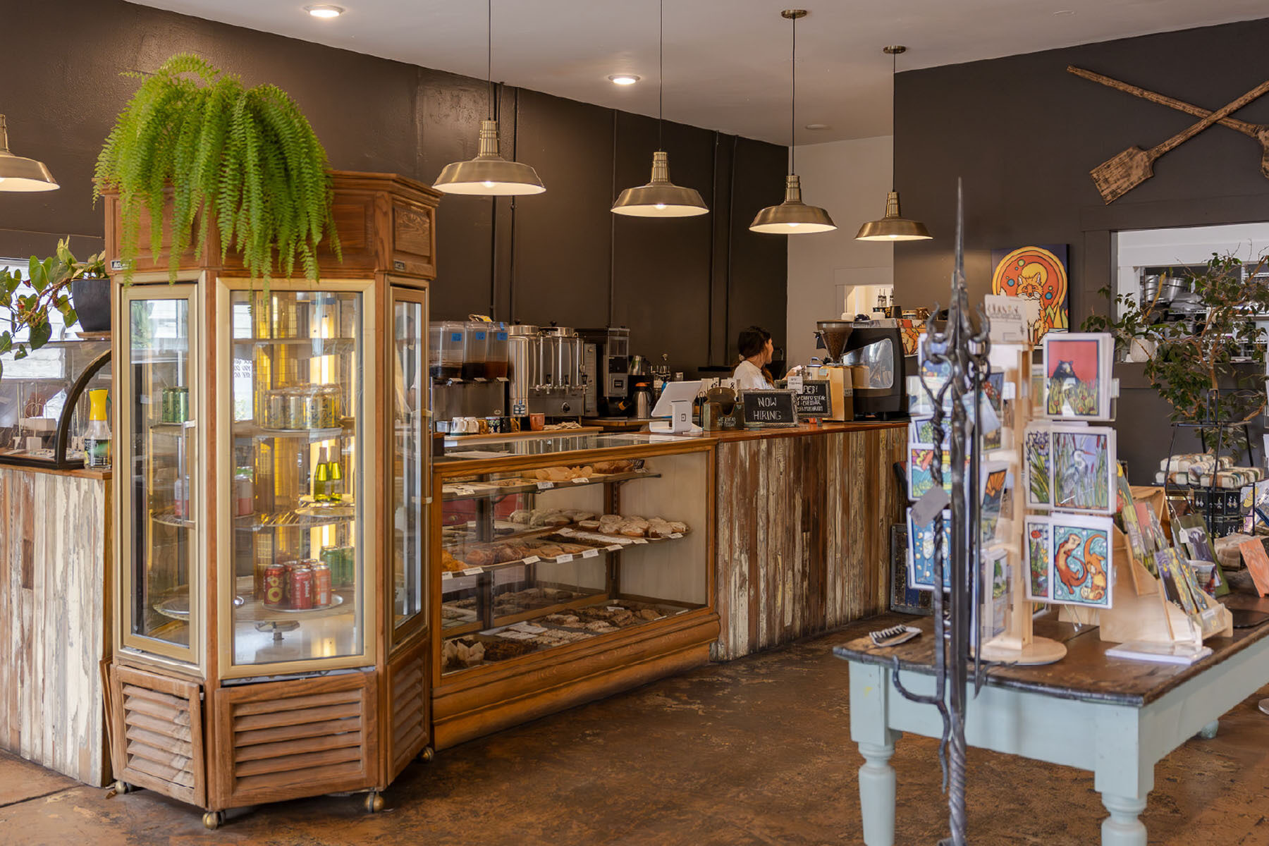The counter at Duke's cafe with a display case full of cookies and pastries