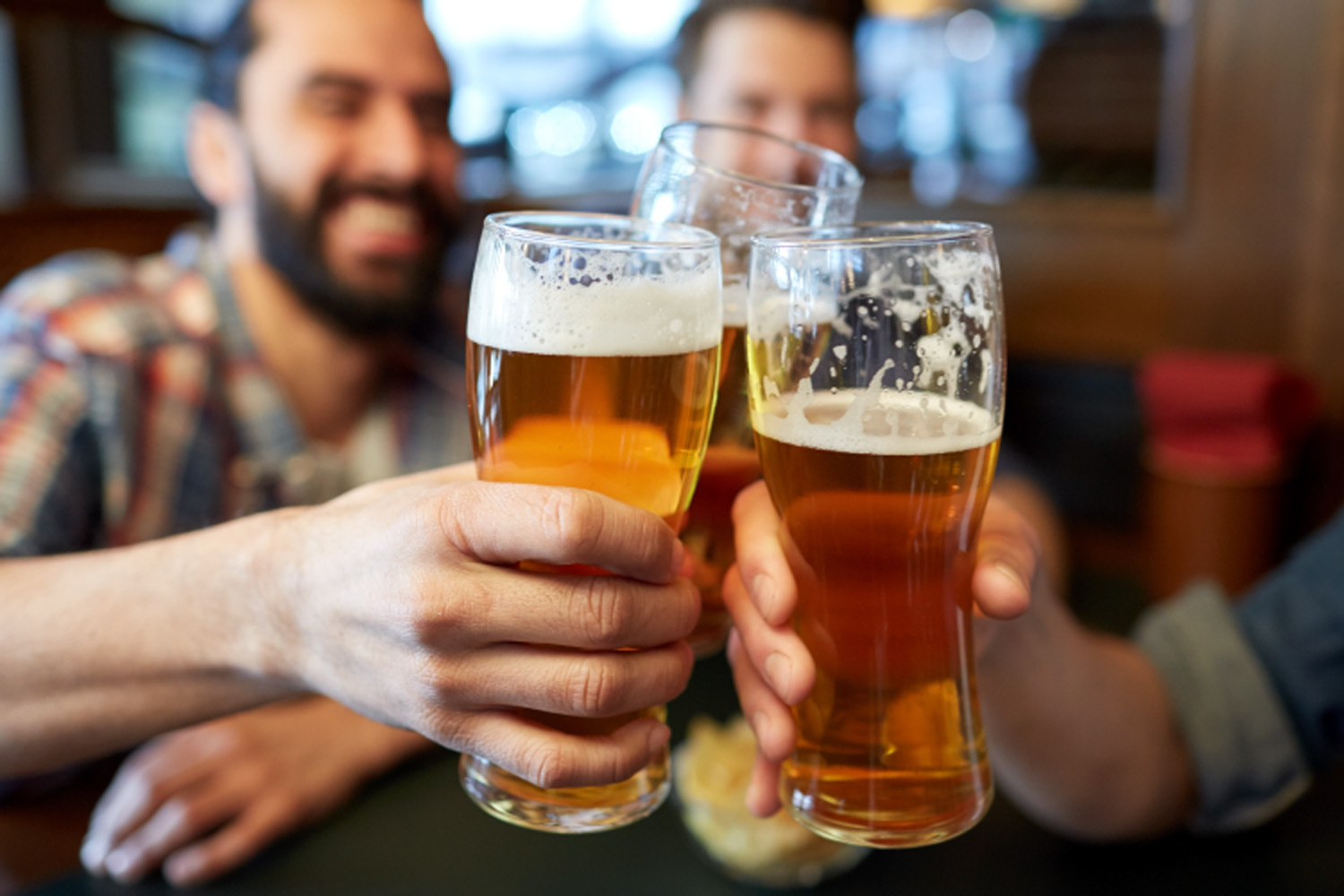 People holding beers, doing a cheers