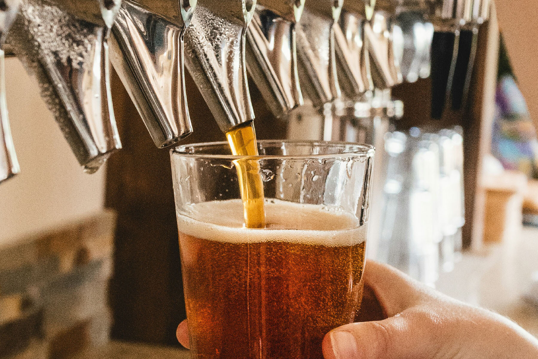 Beer being poured into a glass from a tap